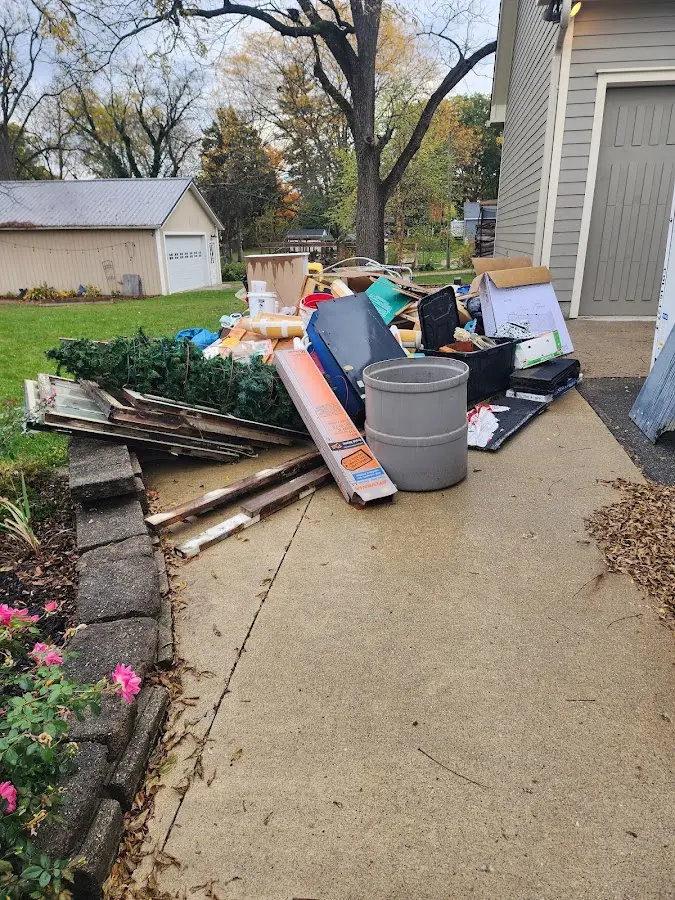 Dumpster being loaded with debris for Commercial Dumpster Rental in Greenville